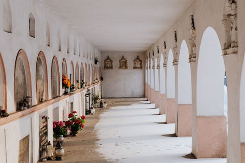 Allée de columbarium sous des arcades, avec des fleurs